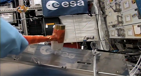 ESA asronaut Thomas Pesquet hammering EC