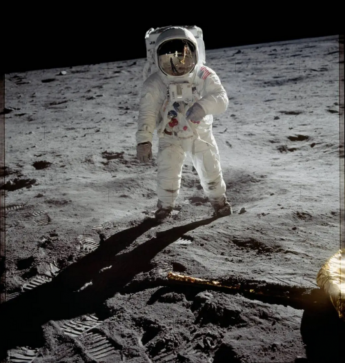 Astronaut Buzz Aldrin walks on the surface of the moon.